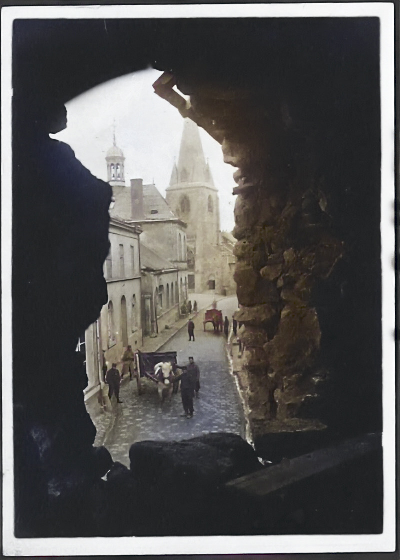 Vue sur la rue, la mairie et l’église depuis une ouverture — octobre 1914